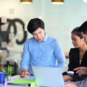 Corporate business team making great business discussion in modern co working office.