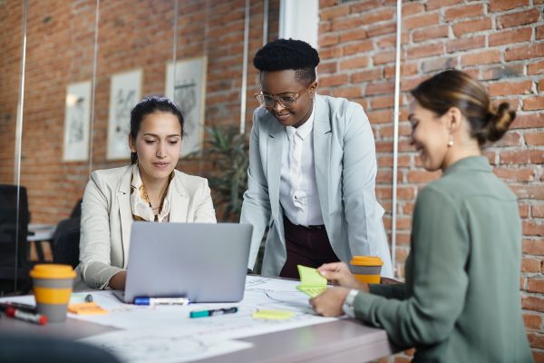 Team of multiracial businesswomen working on a meting at corporate office.