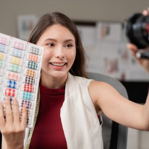 Young fashion designer woman filming live video for selling clothes